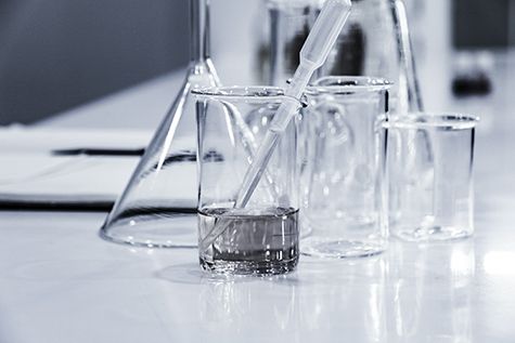 A table of beakers and lab tools